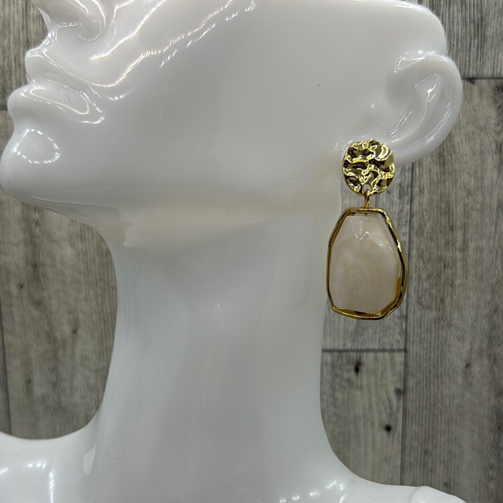 Elegant acrylic stone earrings in golden cream tone.